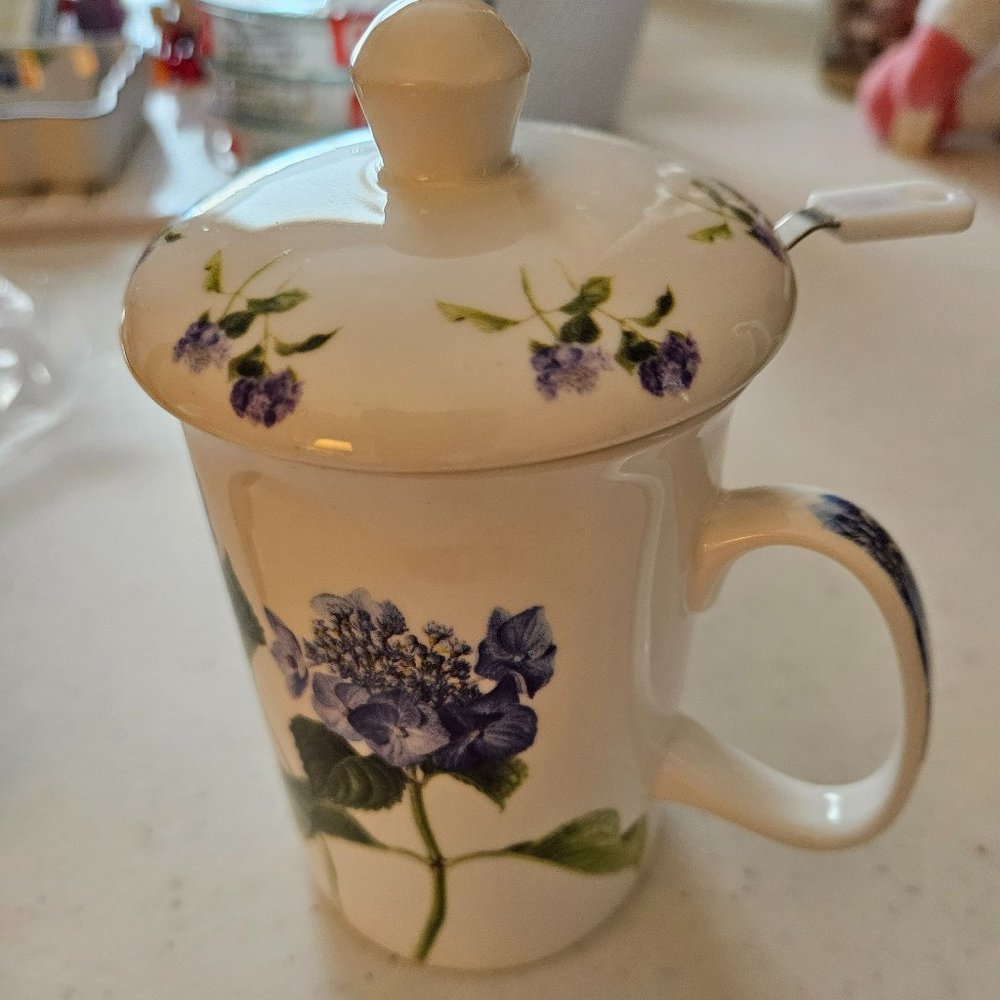 Teacup with strainer for loose tea designed with purple flowers. bone China